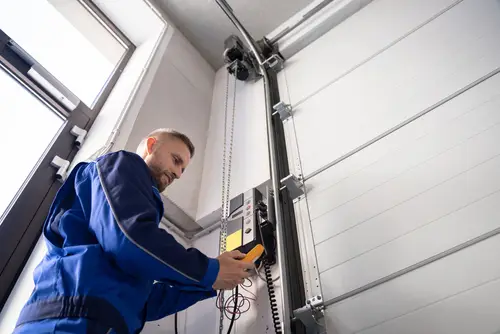 BT1 Doors installer wiring a garage door.